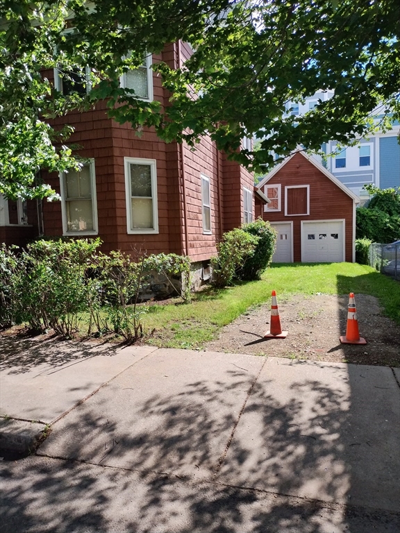 38 Valley Street Everett, MA 02149 - Photo 2 of 2 a front view of a house with a yard and garage