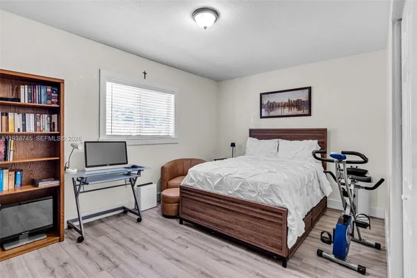 a bedroom with a bed and a bookshelf