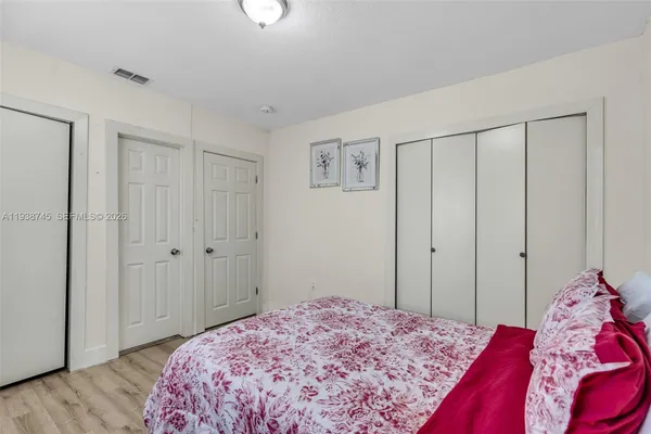 a bedroom with a bed and a closet