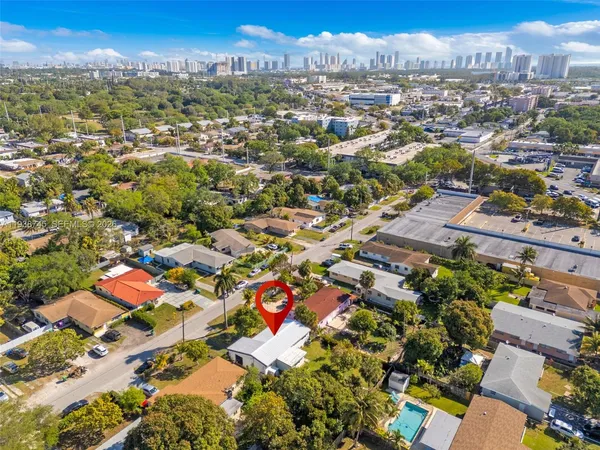 an aerial view of residential houses with city view