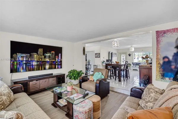 a living room with furniture and a book shelf