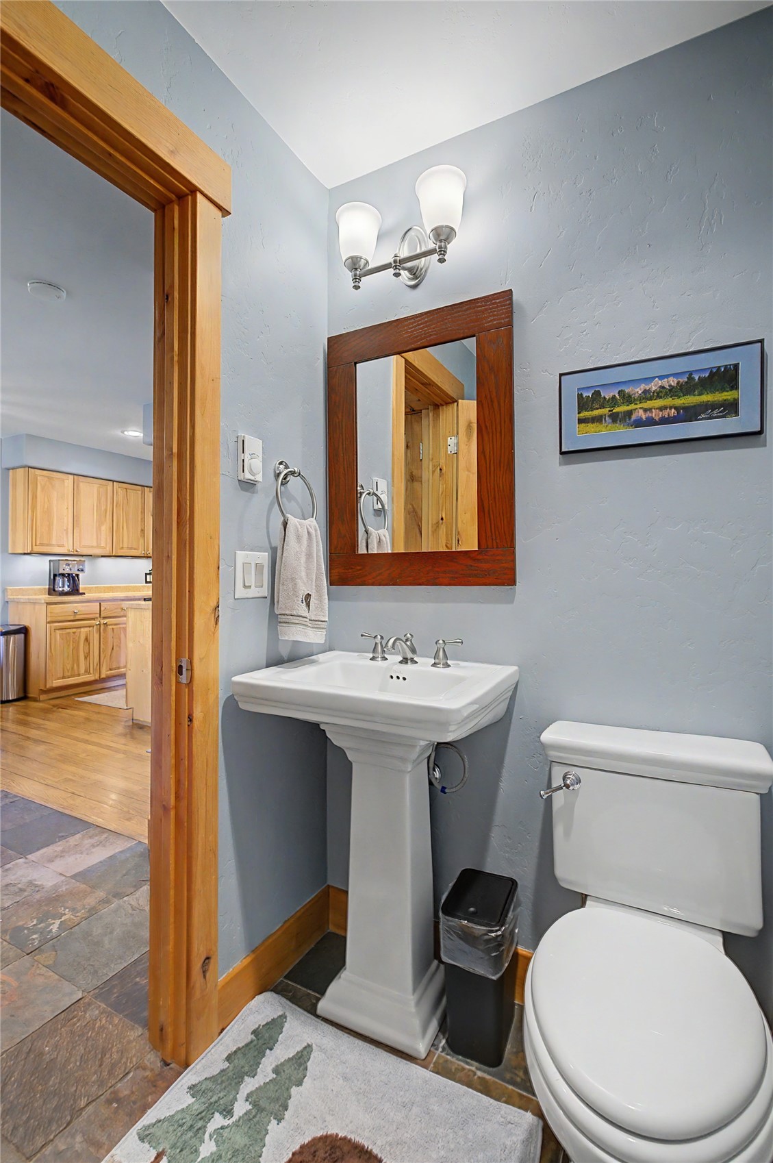 6726 Ryan Gulch Road, Unit 6726 Wildernest, CO 80498 - Photo 29 of 39 a bathroom with a toilet sink and mirror