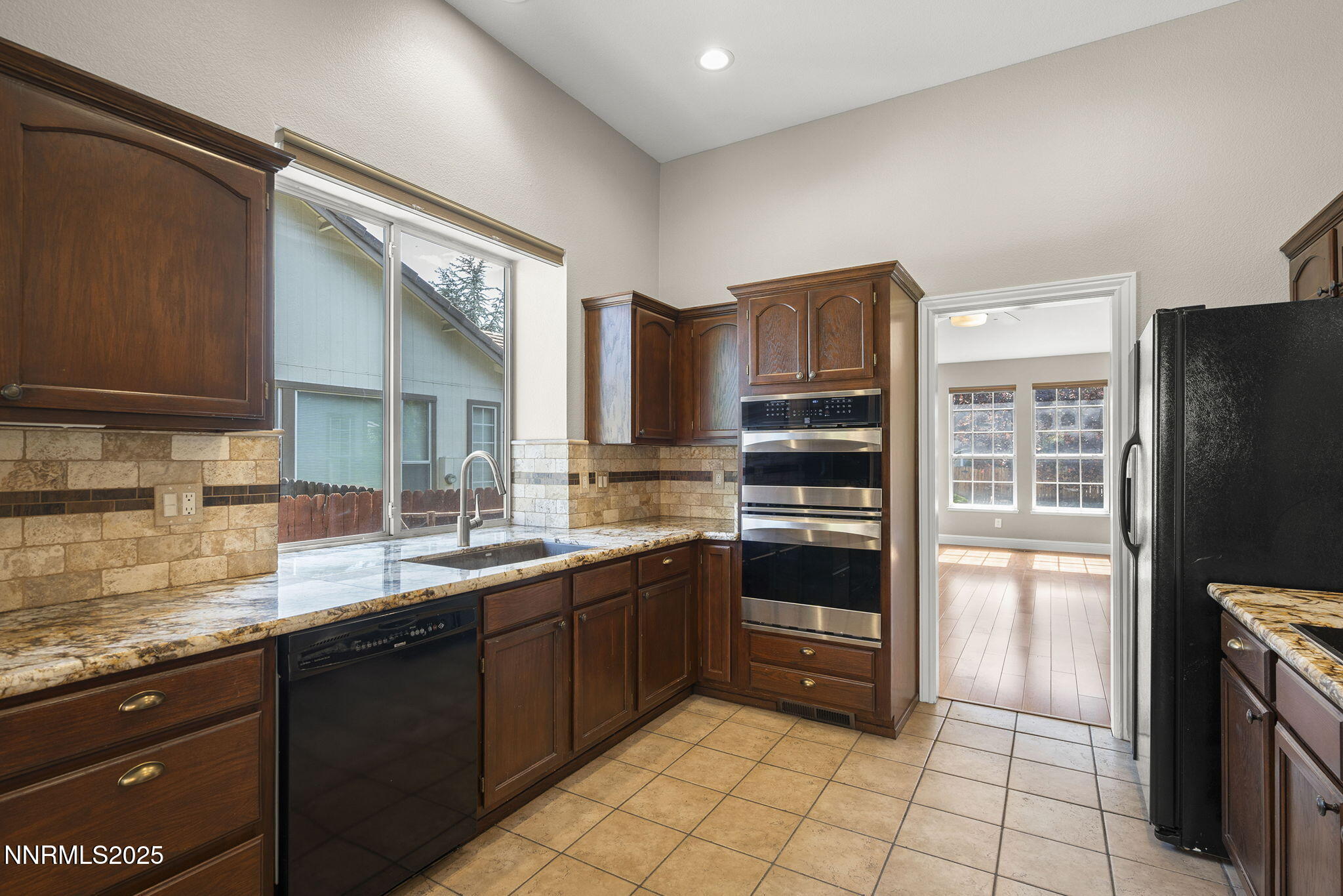 4175 Falling Water Drive Reno, NV 89519 - Photo 12 of 30 a kitchen with stainless steel appliances granite countertop a refrigerator and a sink