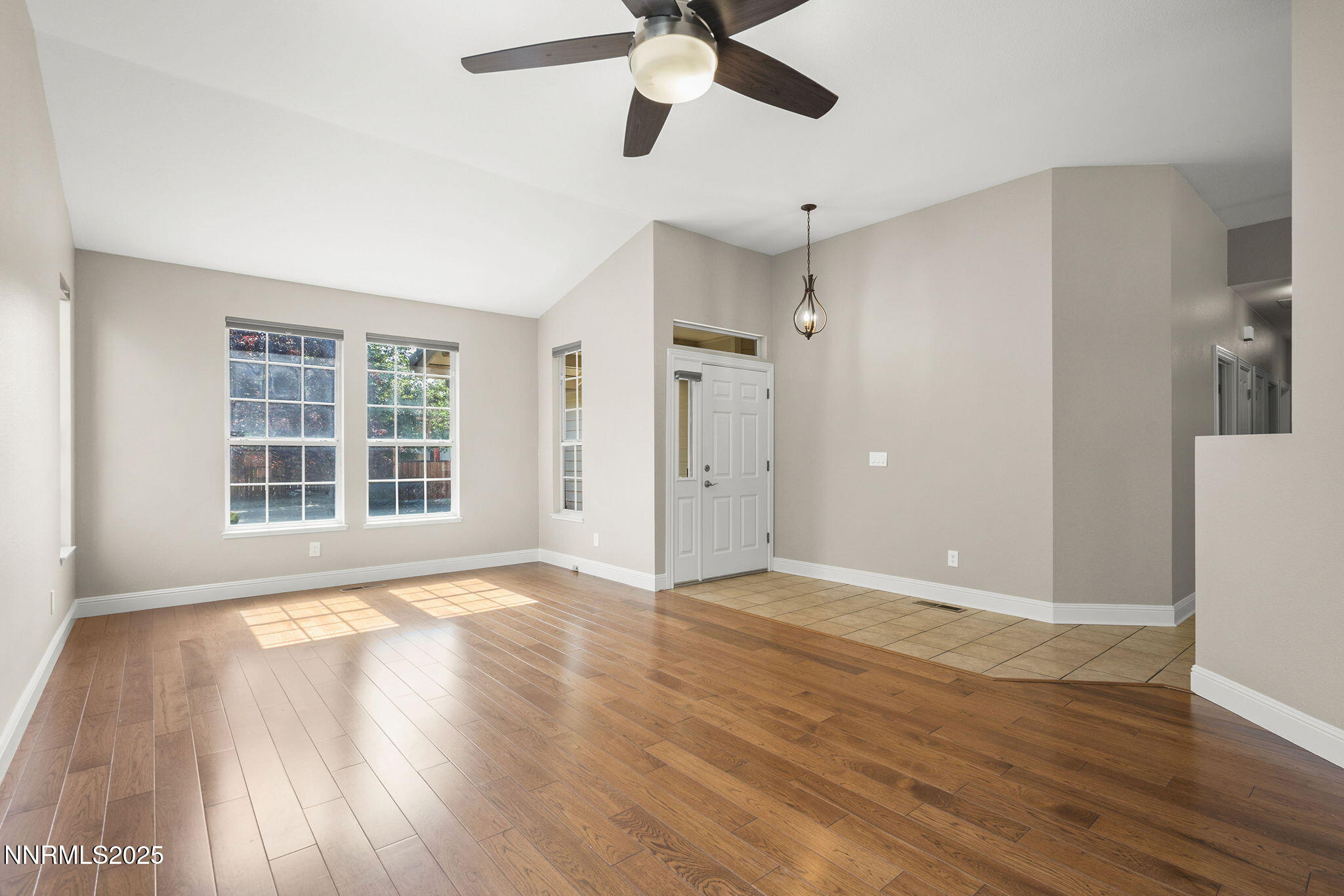 4175 Falling Water Drive Reno, NV 89519 - Photo 8 of 30 a view of an empty room with wooden floor and a window