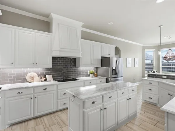 a kitchen with white cabinets and white appliances
