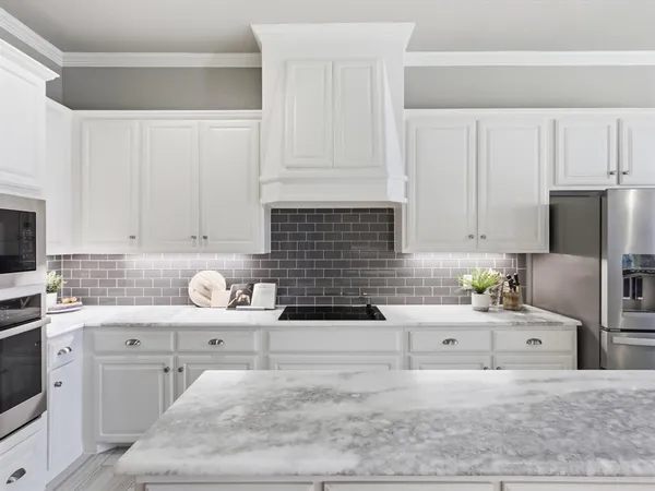 a kitchen with a sink window and cabinets