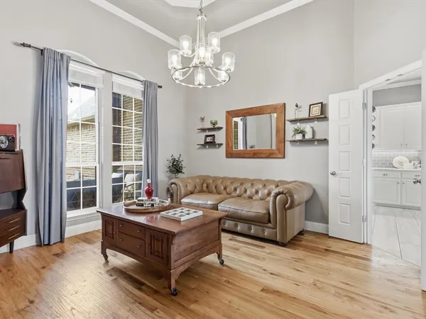 a living room with furniture and a chandelier