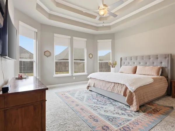 a bedroom with a large bed and a window