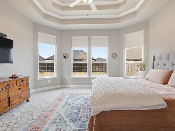 a spacious bedroom with a large bed and a window