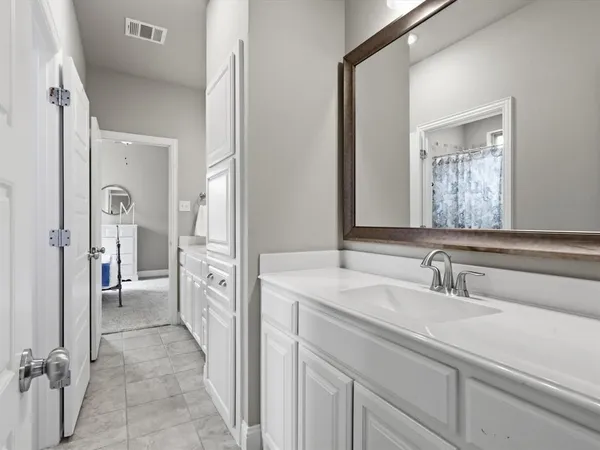 a en suite bathroom with a sink a mirror and a shower