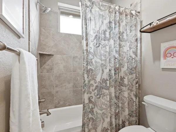 a bathroom with a toilet and shower