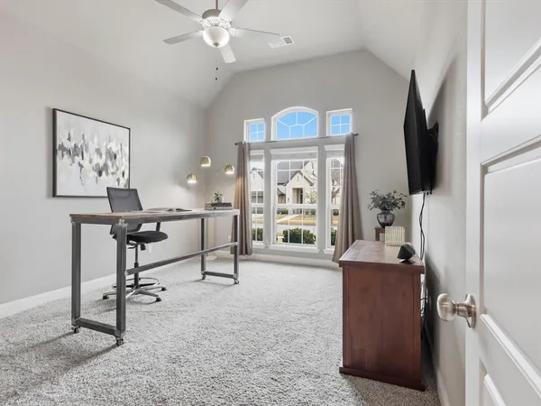 a living room with furniture a window and flat screen tv