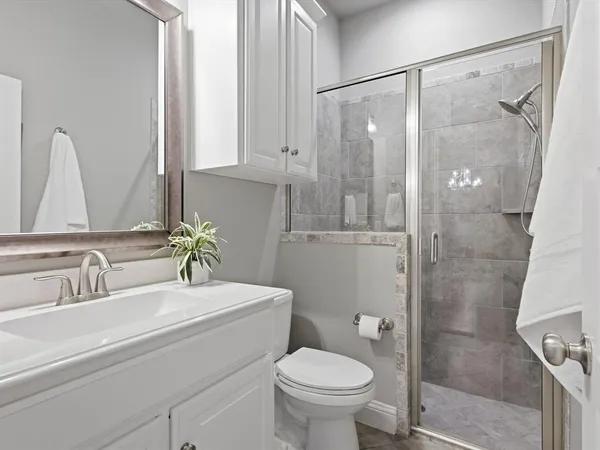 a bathroom with a sink toilet and shower