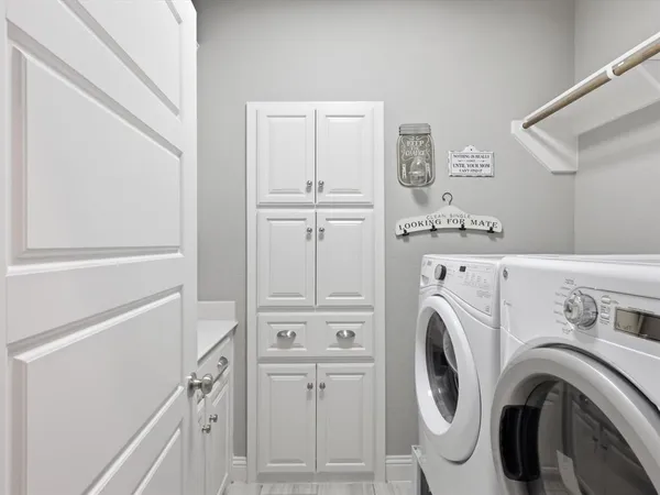 a view of washer and dryer with kitchen in the background
