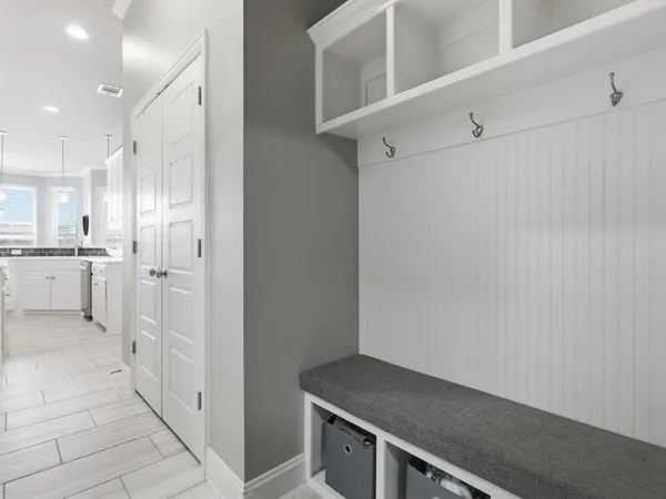 a view of a kitchen with white cabinets