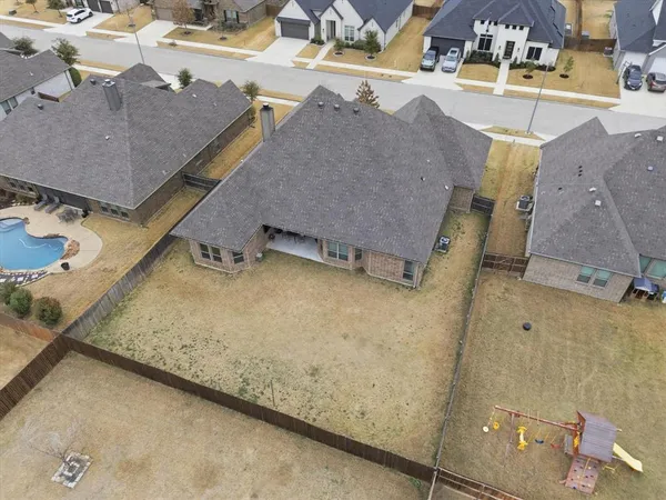 an aerial view of residential houses with outdoor space