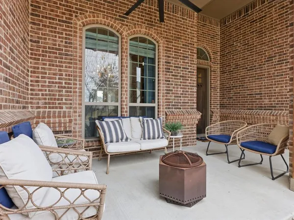 a view of a patio with couches chairs and a potted plant