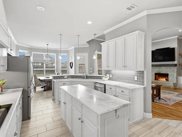 a large white kitchen with a large window