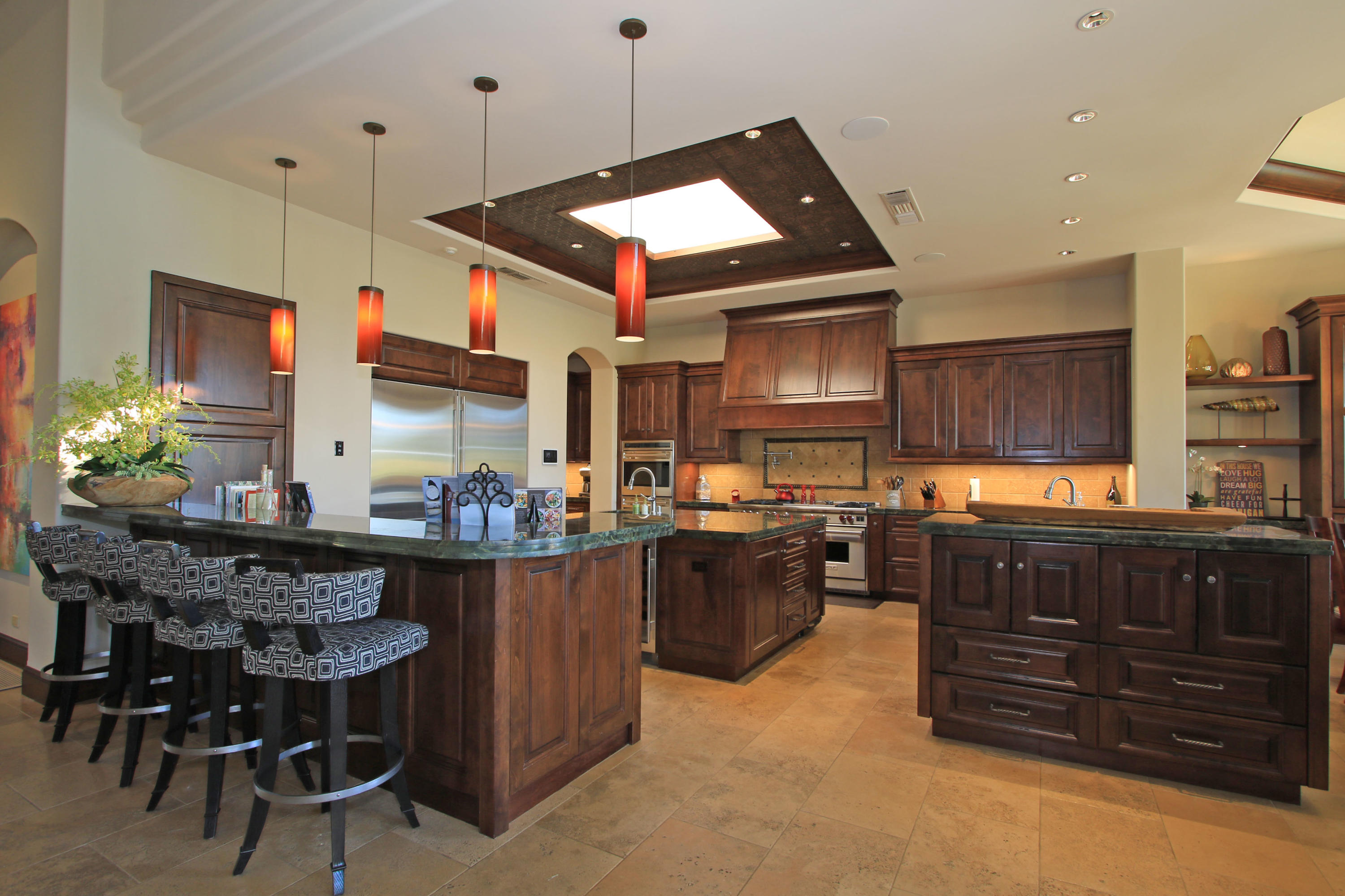 83 Royal St Georges Way Rancho Mirage, CA 92270 - Photo 26 of 123 a kitchen with stainless steel appliances granite countertop a stove refrigerator and cabinets