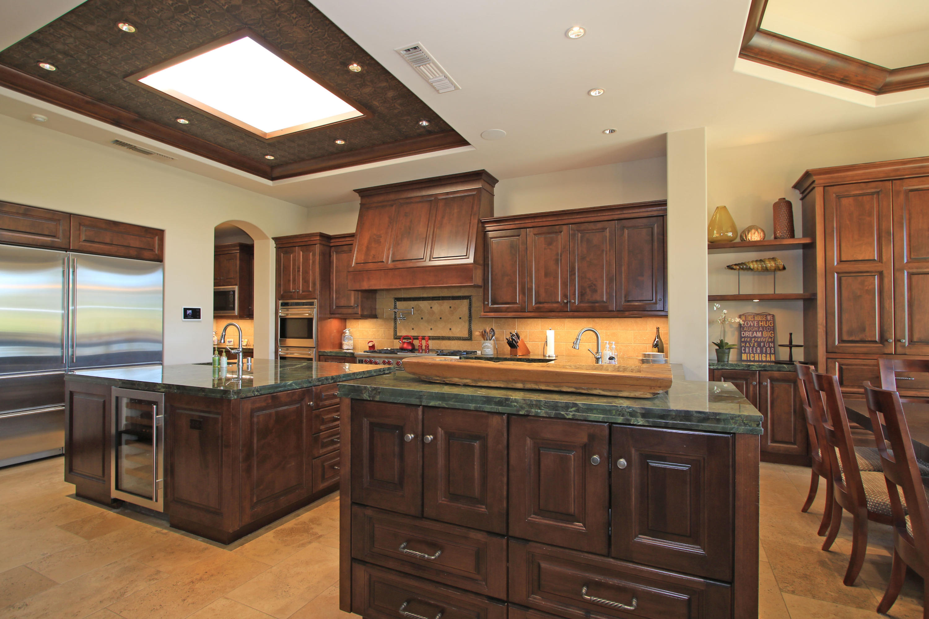 83 Royal St Georges Way Rancho Mirage, CA 92270 - Photo 27 of 123 a kitchen with stainless steel appliances granite countertop a sink and cabinets