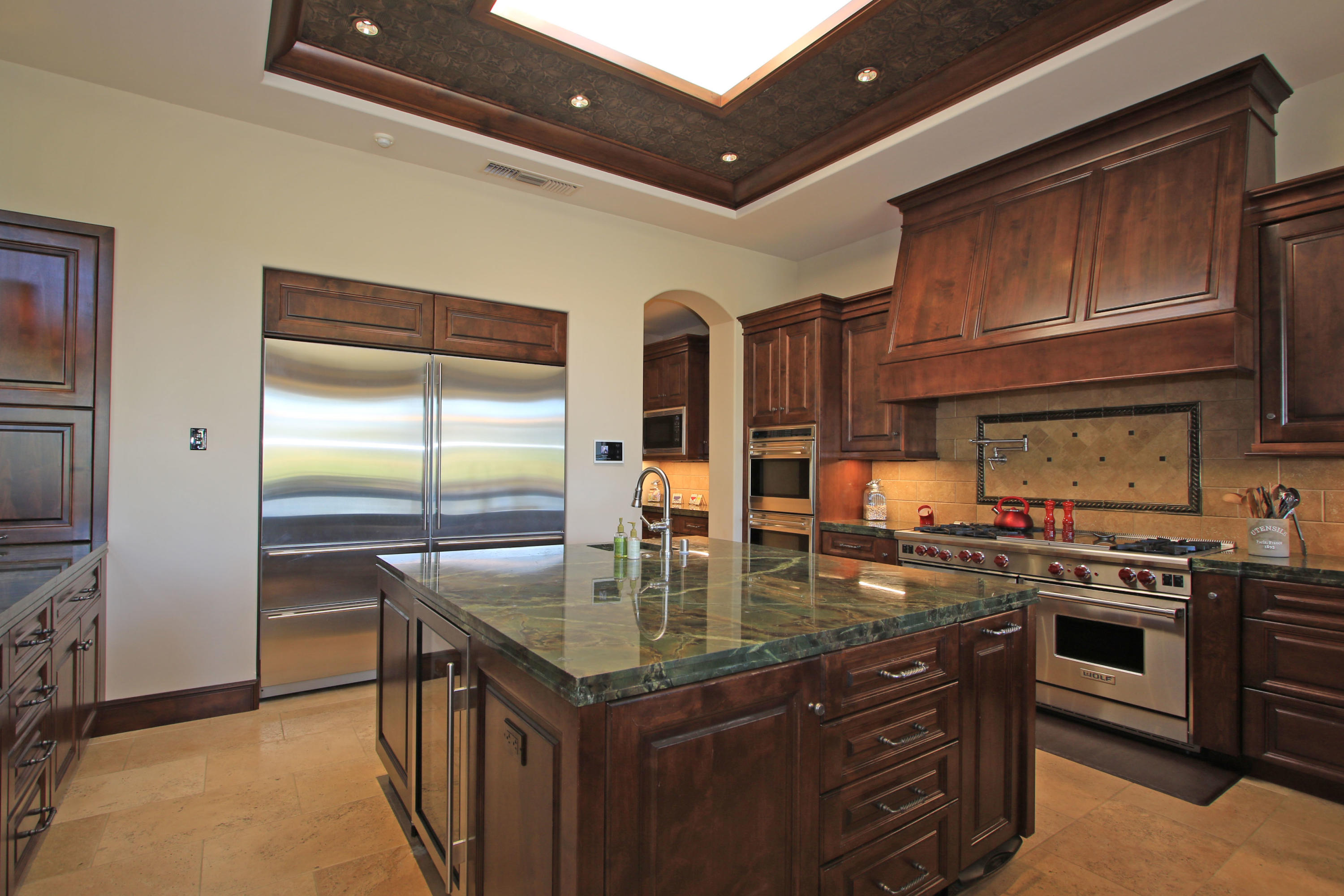 83 Royal St Georges Way Rancho Mirage, CA 92270 - Photo 34 of 123 a kitchen with stainless steel appliances granite countertop a stove a sink and a refrigerator