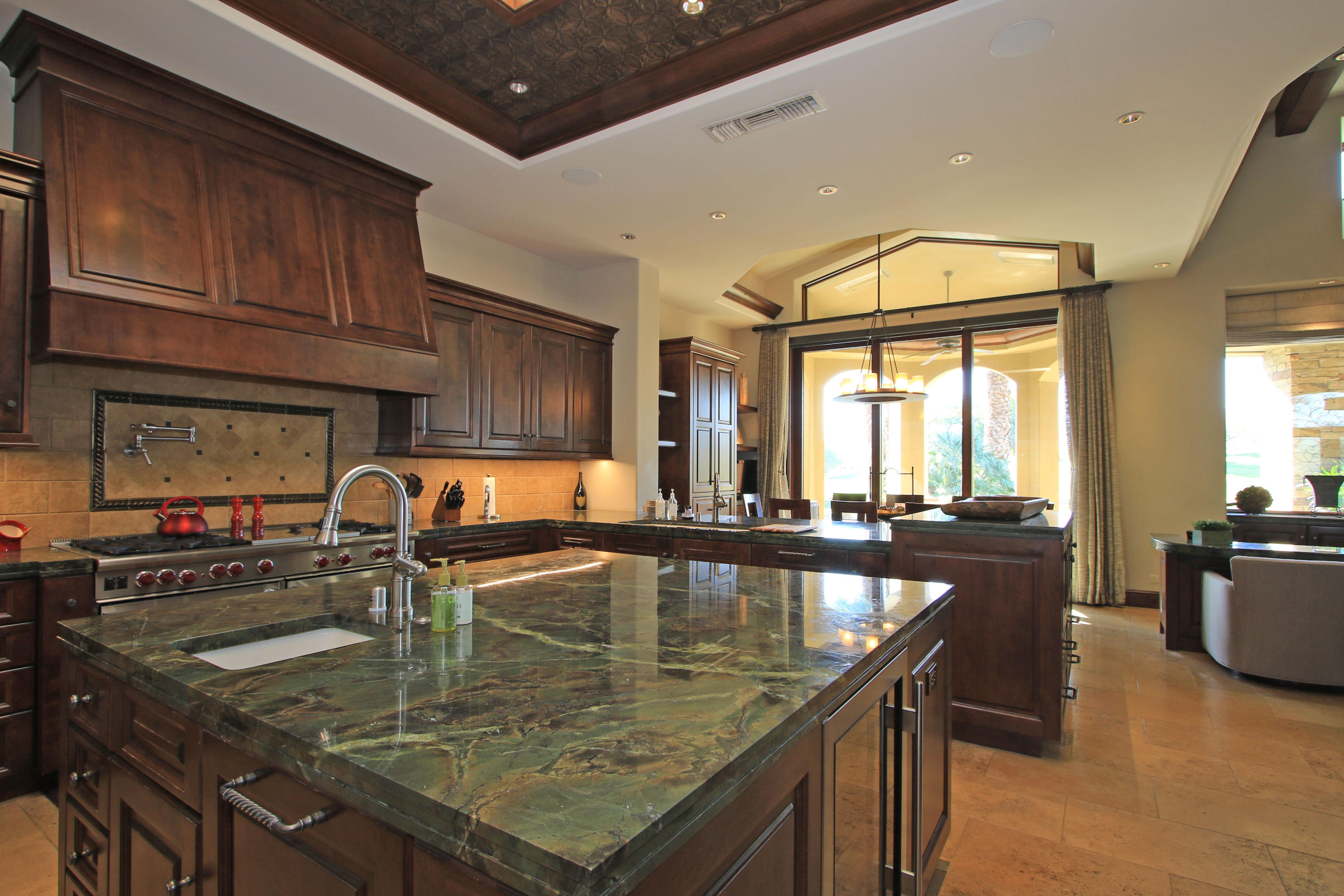 83 Royal St Georges Way Rancho Mirage, CA 92270 - Photo 35 of 123 a kitchen with stainless steel appliances granite countertop a sink a counter space and wooden cabinets