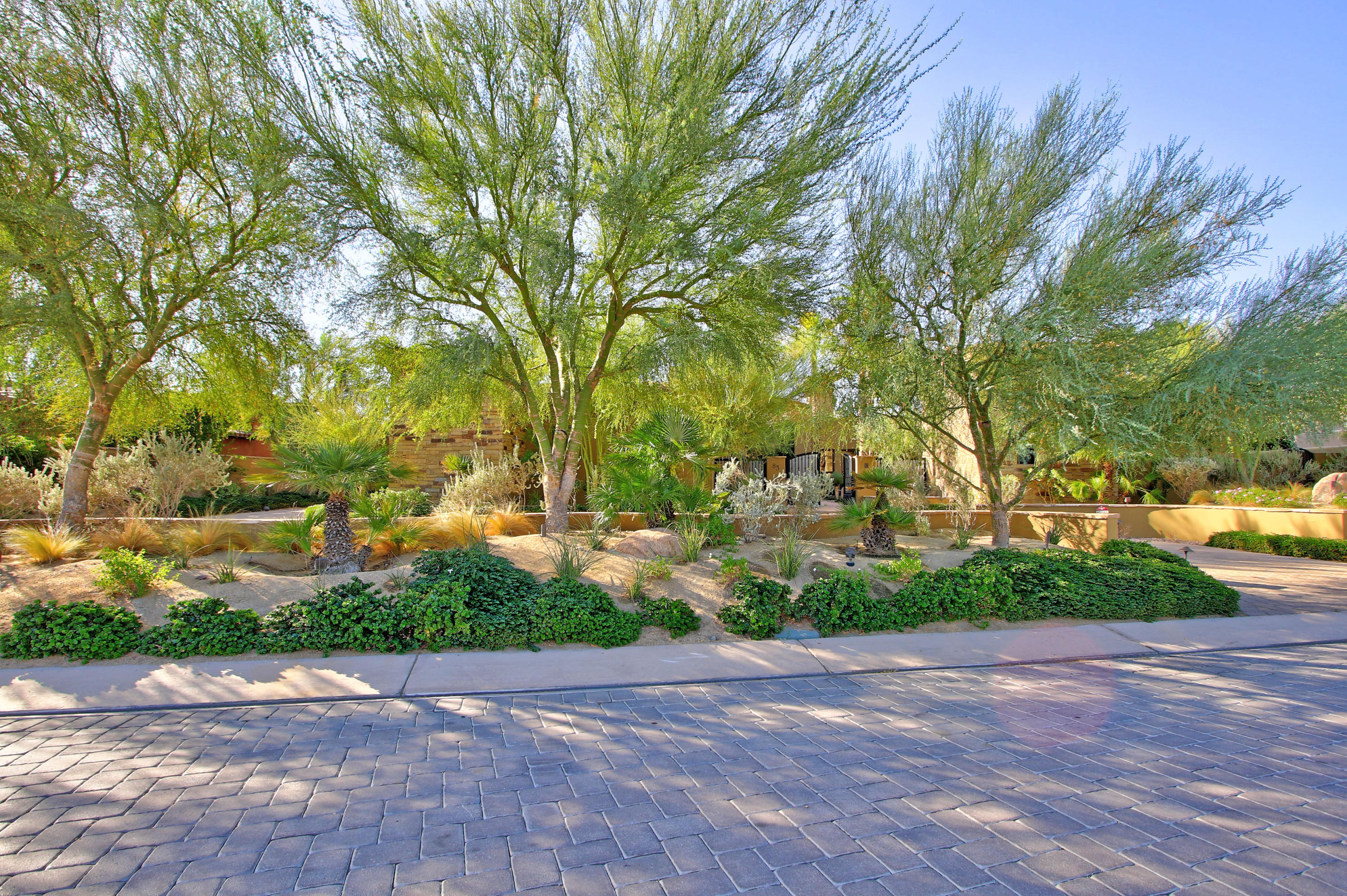 83 Royal St Georges Way Rancho Mirage, CA 92270 - Photo 4 of 123 a view of backyard with plants and trees