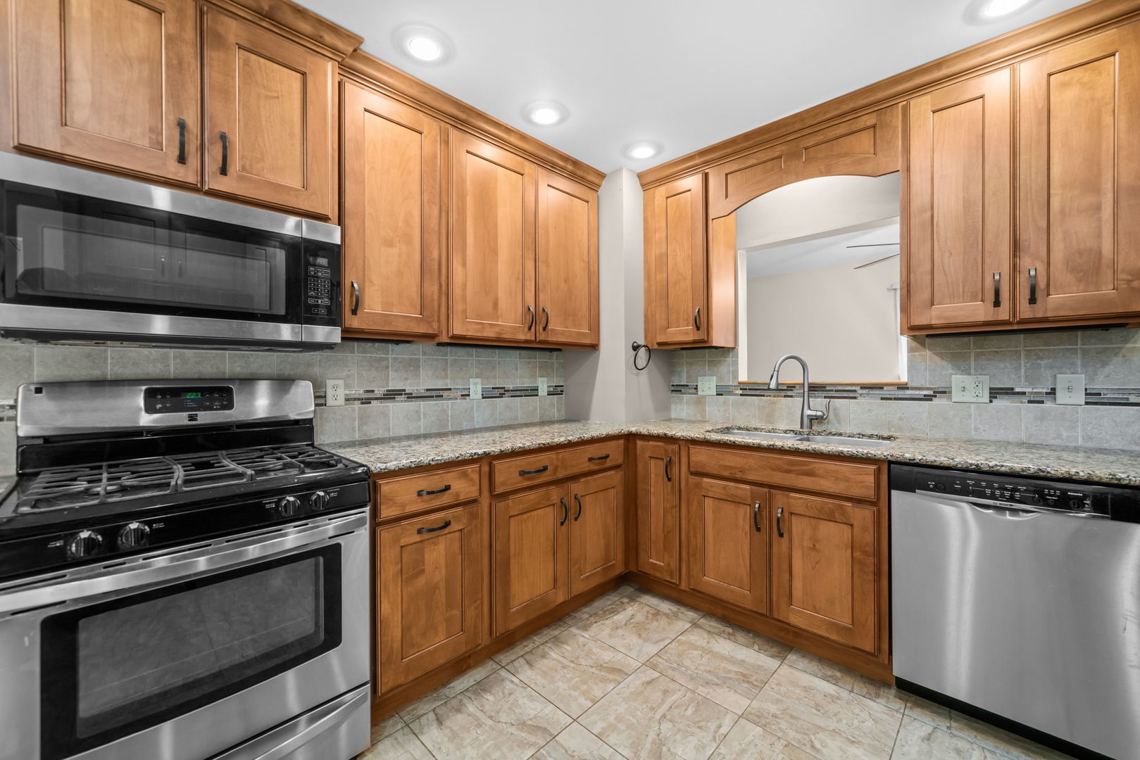 5748 South Skare Road Rochelle, IL 61068 - Photo 4 of 45 a kitchen with stainless steel appliances granite countertop a stove sink microwave and cabinets