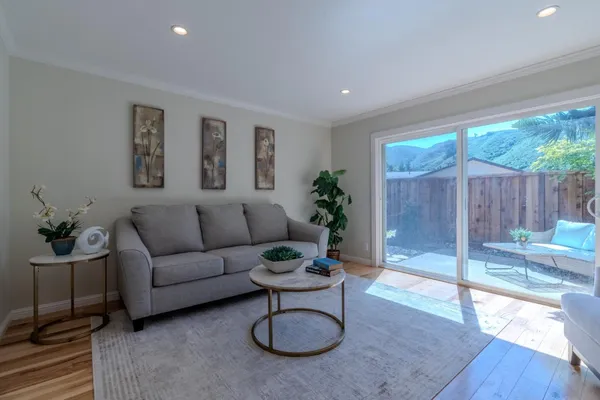 a living room with furniture a table and a potted plant