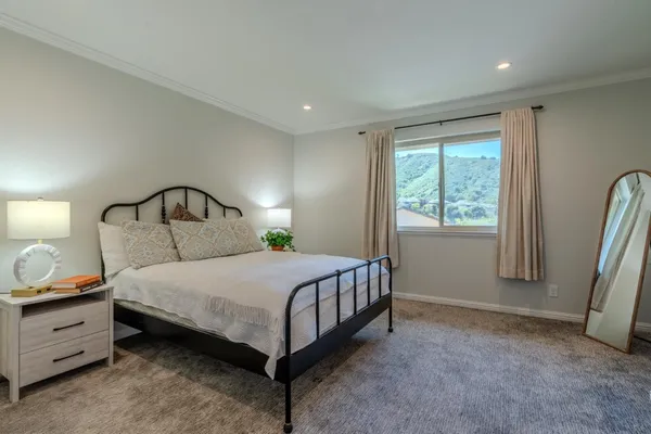 a bedroom with a bed and a mirror