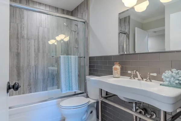 a bathroom with a toilet a sink and mirror