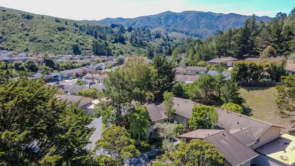 an aerial view of house with mountain view