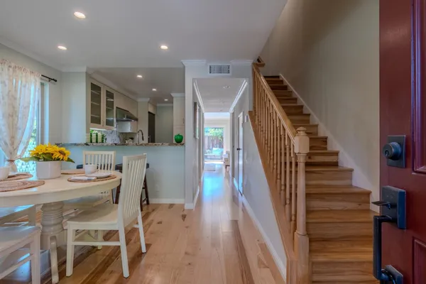 a dining room with furniture and wooden floor