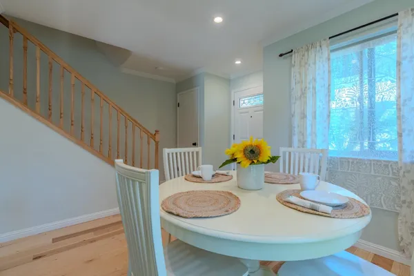 a dining room with furniture and wooden floor