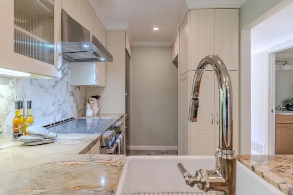 a view of a kitchen with a sink and natural light