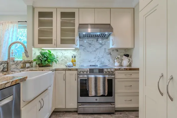 a kitchen with cabinets appliances and a sink