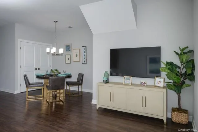 a view of a livingroom with furniture and a potted plant