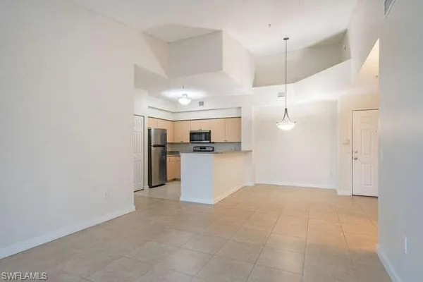 a view of a kitchen with a sink and refrigerator