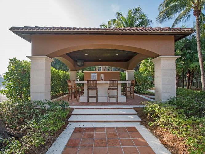 1220 Reserve Way, Unit 305 Naples, FL 34105 - Photo 19 of 20 a porch with seating space and yard