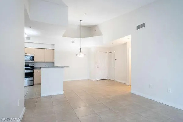 a view of kitchen and refrigerator