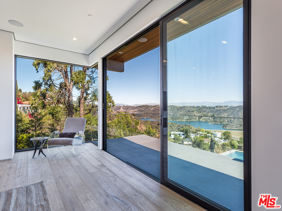 1632 Stradella Road Los Angeles, CA 90077 - Photo 20 of 41 a view of an empty room with wooden floor and a window