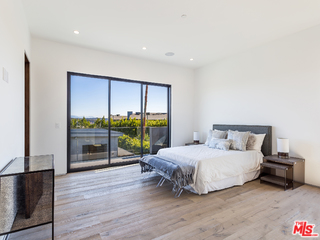 1632 Stradella Road Los Angeles, CA 90077 - Photo 25 of 41 a bedroom with a bed and a view of kitchen