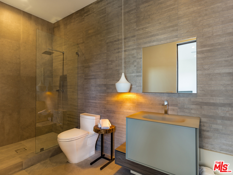 1632 Stradella Road Los Angeles, CA 90077 - Photo 27 of 41 a bathroom with a sink and a mirror