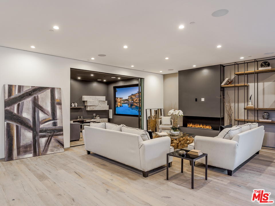 1632 Stradella Road Los Angeles, CA 90077 - Photo 30 of 41 a living room with furniture and a flat screen tv