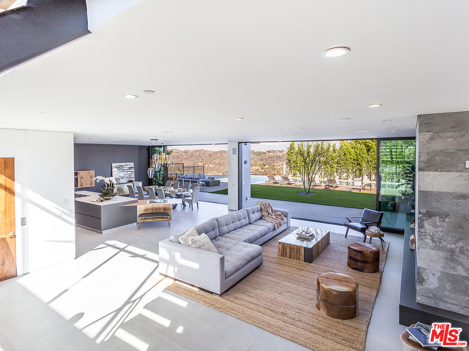 1632 Stradella Road Los Angeles, CA 90077 - Photo 5 of 41 a living room with furniture and a large window