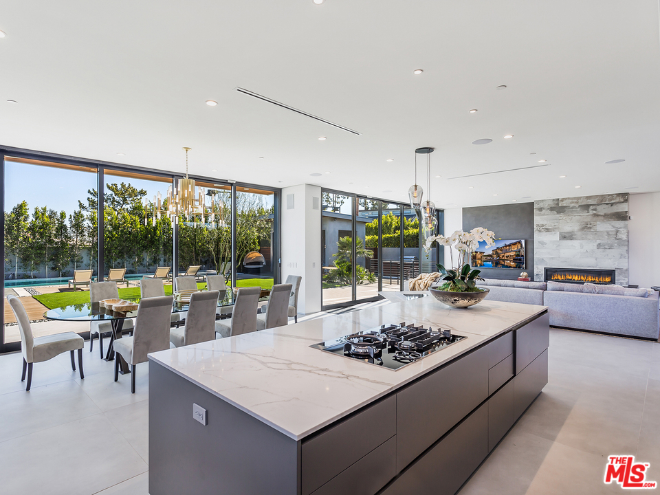 1632 Stradella Road Los Angeles, CA 90077 - Photo 8 of 41 a large kitchen with a table and chairs