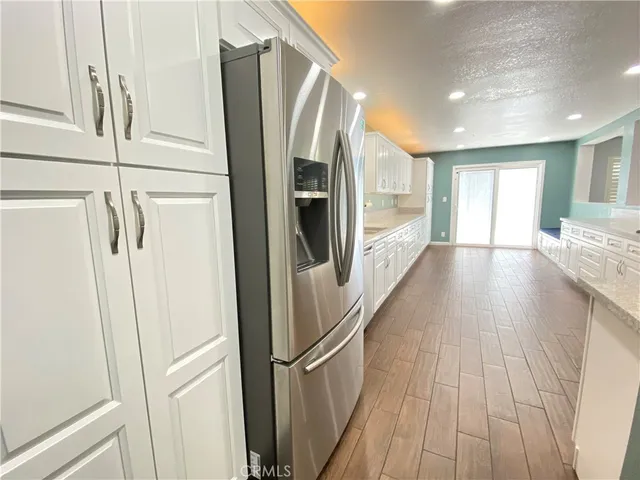 a kitchen with refrigerator and window