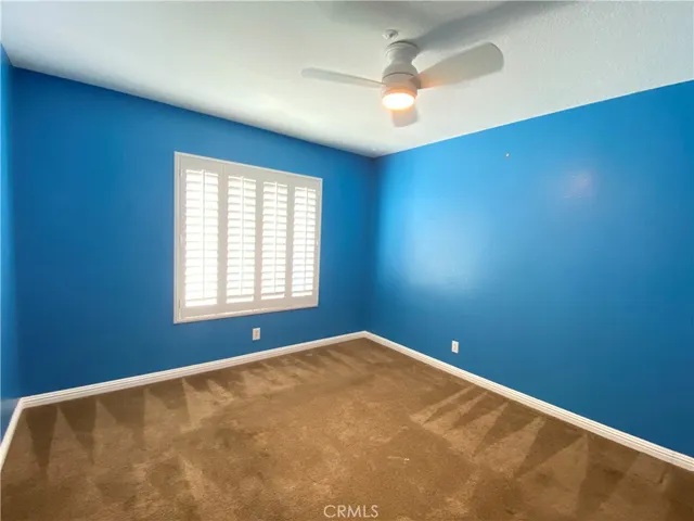 a view of a hallway with stainless steel appliances granite countertop cabinets and a refrigerator