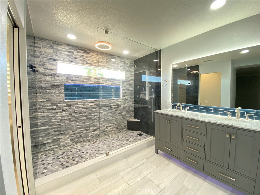 971 Saltcoats Drive Riverside, CA 92508 - Photo 28 of 50 a bathroom with a sink and a large mirror