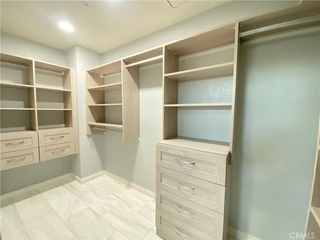 an empty room with a window and a ceiling fan